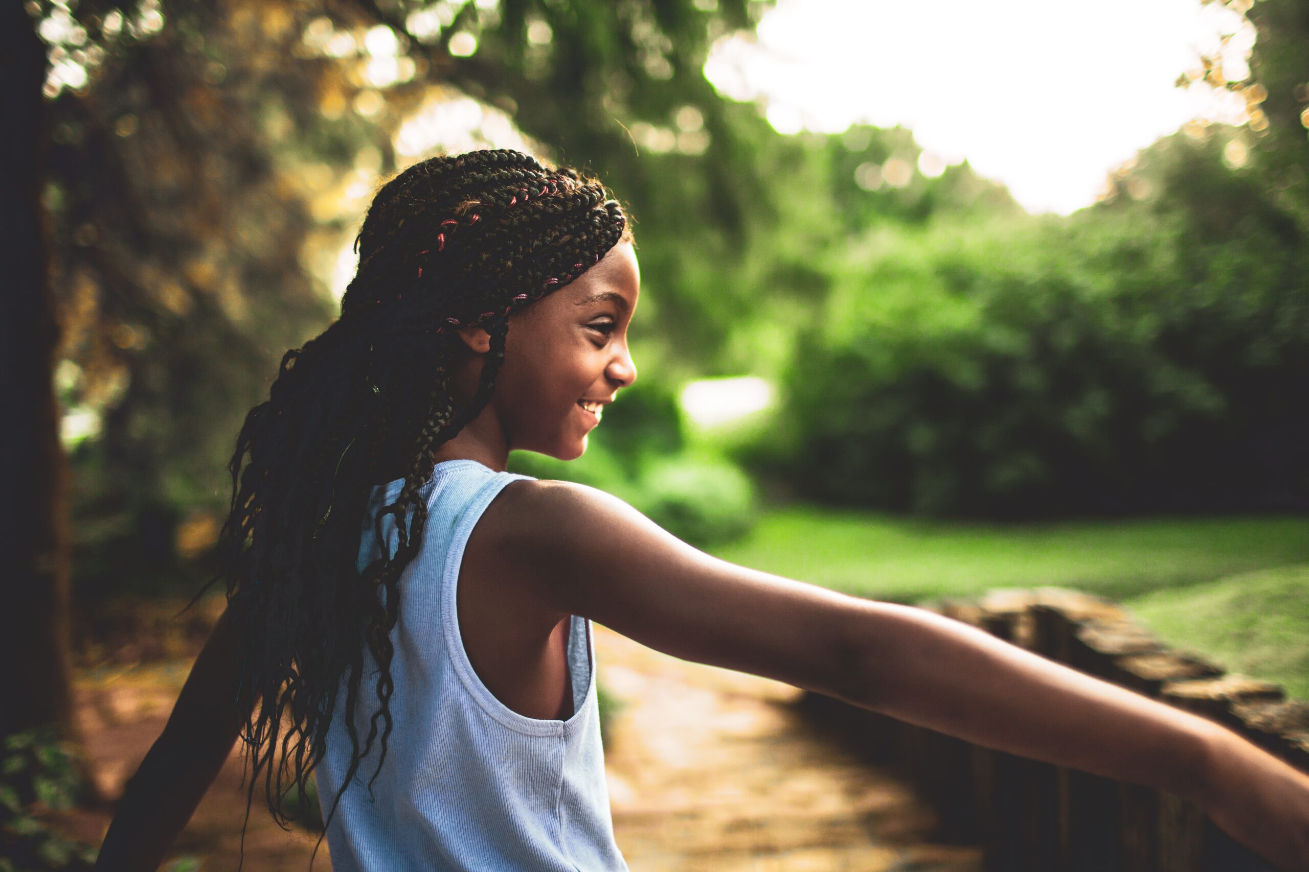 young black person smiling and enjoying nature