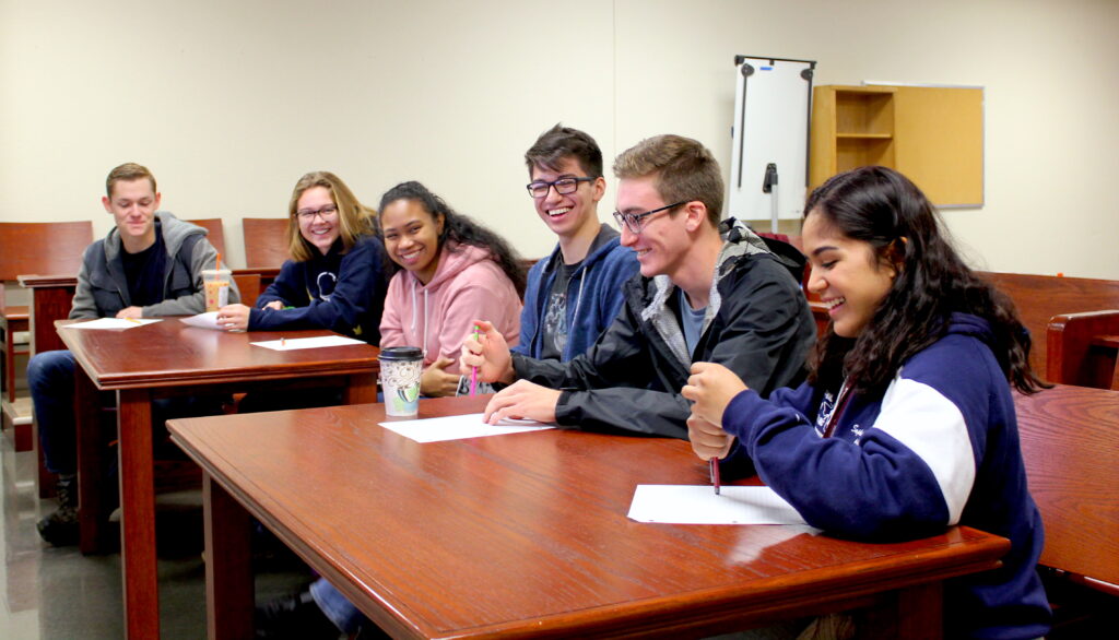 6 green building interns sitting in a classroom and laughing together